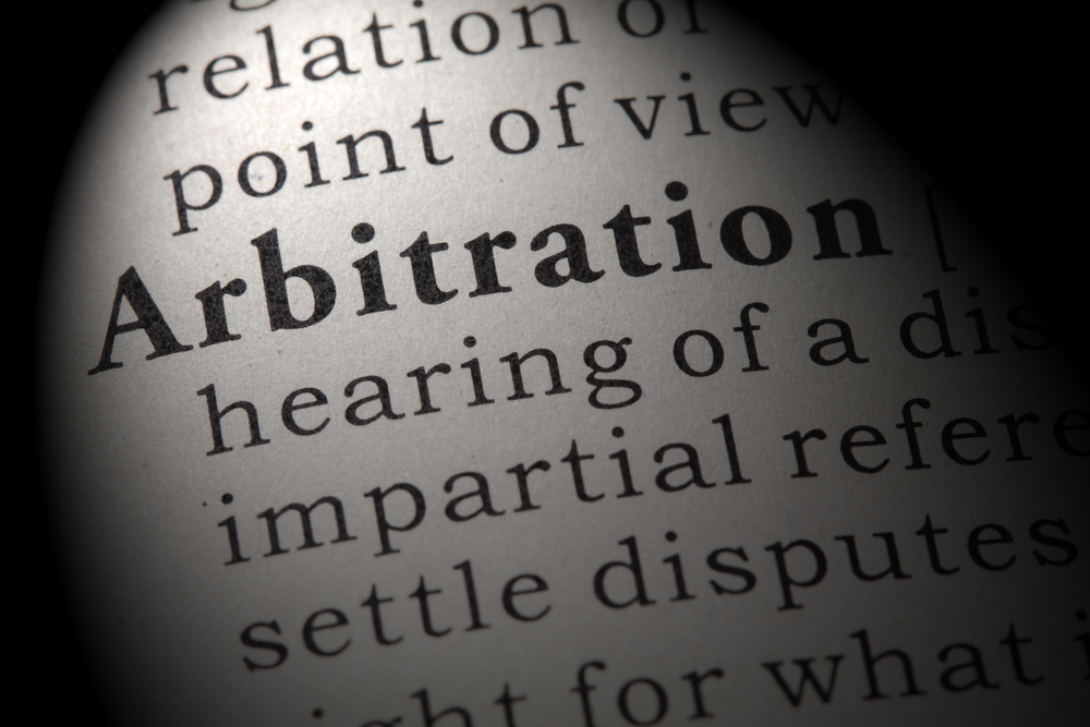 real_estate_law image shows dictionary page with definition of arbitration on it.