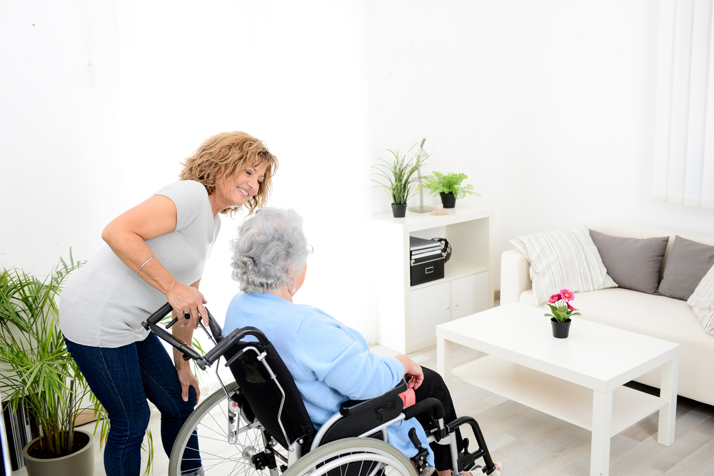 image shows elderly woman in wheel chair
